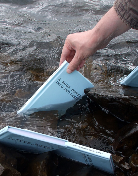 Books being dipped in Meldon Reservoir (2015)